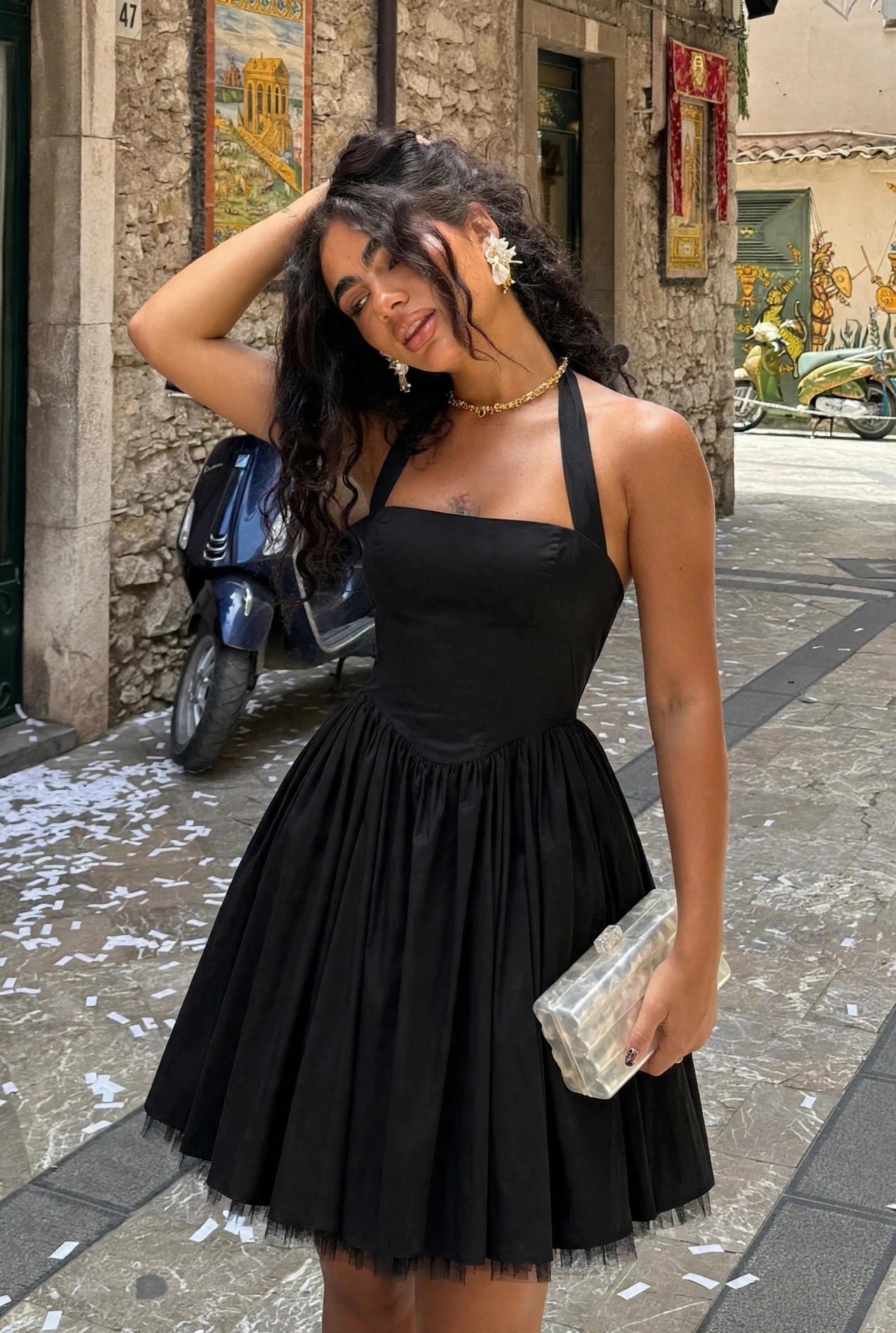 Lena black halter neck midi dress with tulle-trimmed hem - front view, street setting